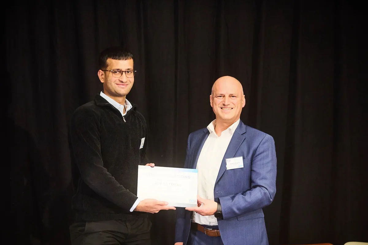 Kshitij receiving the first-place award at PAVE Europe in Brussels